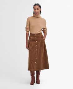 If you're looking for a new way to elevate your wardrobe without investing in bright colours or prints, we recommend trying texture. The Barbour Samara Cord Midi Skirt offers a sophisticated and timeless A-line silhouette crafted from soft cotton corduroy and detailed with angled pockets for extra dimension. Fastened with bright brass, branded snap button closure and ID tag to the waist, this style complements shirts and T-shirts alike for a versatile addition to your wardrobe. Corduroy Midi Skirt Outfit, Brown Midi Skirt, Corduroy Skirt Outfit Winter, Corduroy Skirt Outfit Fall, Brown Corduroy Skirt Outfit, Suede Midi Skirt, Corduroy Midi Skirt, Cord Skirt Outfit, Brown Skirt