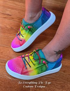 Lighten your step and slip into comfort and style with custom colored HEY DUDE Cody style sneakers! Hand-colored with a beautiful meld of bright rainbow tones, these gorgeous shoes will turn heads! With the eyelet upper and rainbow elastic laces plus beads for a secure fit, this Cody sneaker is one of cutest and comfiest shoes out there. With a removable memory foam insole and this shoe offers ergonomic comfort and cushioning, the ultralight outsole sets you free to explore in comfort and style! Trendy Breathable Slip-on Canvas Shoes, Colorful Casual Lace-up Sneakers, Trendy Custom Breathable Lace-up Sneakers, Sporty Multicolor Slip-on Sneakers With Round Toe, Casual Multicolor Custom Sneakers With Vulcanized Sole, Casual Multicolor Slip-on Sneakers For Spring, Trendy Colorful Lace-up Sneakers, Trendy Multicolor Slip-on Sneakers, Colorful Lace-up Casual Sneakers