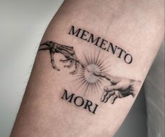 a man with a tattoo on his arm that says mementoo mor