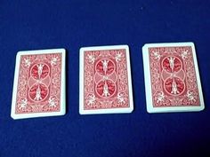 three red playing cards sitting on top of a blue table with the words,'how to