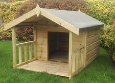 a small wooden dog house in the grass