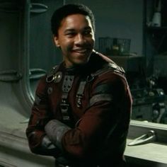 a man in a space suit is smiling at the camera with his arms folded out