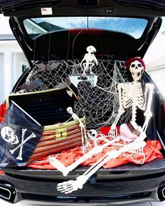 the trunk of a car with skeleton decorations in it