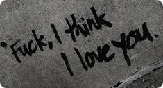 graffiti written on the sidewalk says, i think i love you in black and white