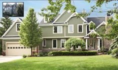 a large house with lots of windows in the front yard