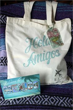 a white bag sitting on top of a chair next to a book and a tag