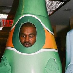 a man in a green and orange rocket costume