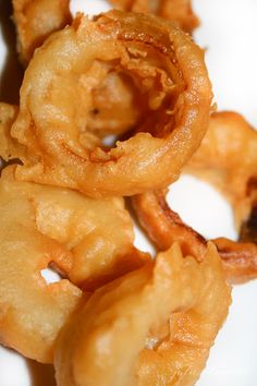 fried onion rings on a white plate ready to be eaten by the cameraman or photographer