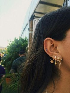 a close up of a person wearing earring and looking at something in the distance