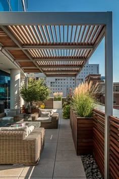 an outdoor living area with couches, tables and potted plants on the roof