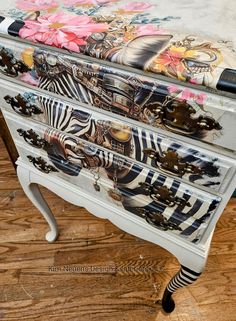 an ornate painted dresser with zebras and flowers on it