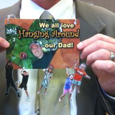 a man in a suit holding up a card that says we all love hanging around our dad