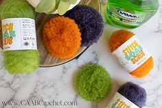 several balls of yarn sitting on top of a table next to a bottle of soap