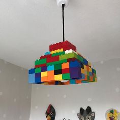 a light fixture made out of lego blocks hangs from the ceiling in a child's room