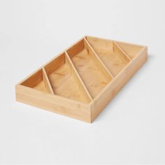 an empty wooden tray with six compartments on the bottom and one section open to show it's contents