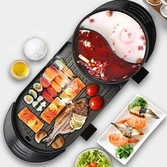 an electric grill with sushi and other food items on the table next to it