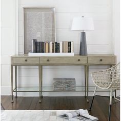 a book is sitting on top of a table next to a lamp and some books