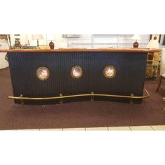 a black and gold table with three round windows