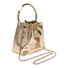 Jimmy Choo gold Bon Bon bucket bag, coulisse closure with chain, inside pocket, metal handle, shoulder strap Composition: 100% Fabric, 100% Metal Jimmy Choo Gold, Zegna Shoes, Bon Bon, Footwear Design Women, Gorgeous Bags, Sneaker Wedge, Sneaker Brands, Tory Burch Shoes, Luxury Retail