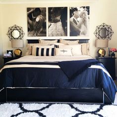 a large bed sitting in a bedroom next to two pictures on the wall above it