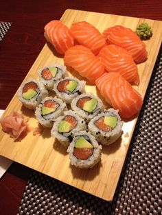 some sushi is laying on a wooden tray