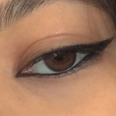 a woman's eye with long lashes and brown eyeshadow