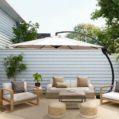 an outdoor living area with furniture and umbrella