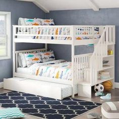 a child's bedroom with blue walls and white bunk beds in the corner, along with a soccer ball on the floor