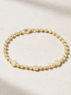 Gemella's 'Double Bubble' bracelet showcases the brand's affinity for timeless yet playful design. Crafted from 18-karat gold, it's made up of dainty beads and punctuated with glinting bezel-set diamonds. For maximum impact, pair yours with the coordinating necklace in our edit. Luxury 14k Yellow Gold Beaded Bracelets, Yellow Gold Diamond Beaded Jubilee Bracelet, Modern Hand Set Yellow Gold Bracelets, Modern Hand Set Yellow Gold Bracelet, Modern Hand-set Yellow Gold Bracelet, Modern Yellow Gold Bracelets With Bezel Setting, Luxury Diamond Bracelet With Bezel Setting For Everyday, Luxury Everyday Diamond Bracelet With Bezel Setting, Modern Yellow Gold Diamond Bracelet With Bezel Setting