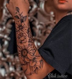 a woman with a flower tattoo on her arm