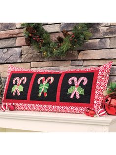 a christmas pillow sitting on top of a mantle