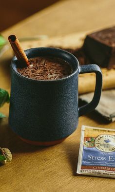 a cup of hot chocolate next to a bar of cocoa