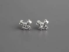 Mini silver bow stud earrings with loop.* Ear stud posts are bendable and may arrive bent. They can be easily be bent back into shape by hand or with pliers.Quantity: 4pcs (2 pair)Material: Silver tone metal alloySize: 12.5 x 10mm (0.49 x 0.4") Silver Earring Studs, Small Earrings Silver, Bow Earrings Silver, Silver Bow Earrings, Cute Earrings Studs, Freetime Activities, Mini Bow, Silver Jewelry Earrings, Mini Bows