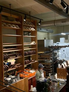 two people working in a bakery with shelves full of bread