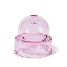 a pink glass bowl sitting on top of a white table