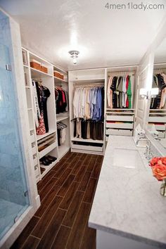 a walk in closet filled with lots of clothes