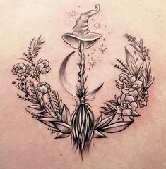 a woman's back with an image of a wizard hat and flowers on it