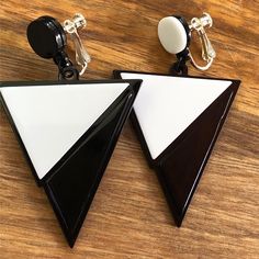 Dangling clip on earrings. Large asymmetrical black and white dangling triangles on hinged screwback  closures. Adjustable, lightweight, retro look.  Earrings are not intended to be worn while sleeping bathing or swimming. Not recommended for children. See more: https://www.etsy.com/ca/shop/CleverLittleEars CANADIAN PRICES INCLUDE GST/HST WHERE APPLICABLE. ETSY WILL CALCULATE ANY PST OWING AT CHECKOUT. While the cost of shipping makes returns or exchanges impractical, please do contact me with any concerns about your order and we will work together to address them.  By law, European buyers have 14 days from receipt to request a return. Return shipping costs will not be covered by CleverLittleEars. Black Triangle Earring, Retro Look, Triangles, Clip On, Clip On Earrings, Etsy Gifts, Etsy Earrings, Handmade Items, Jewelry Earrings