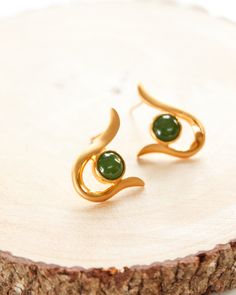 These natural green nephrite modern round jade stud earrings are set in brass with gold plating. The setting has a matte satin finish to compliment the jade. These earrings make the perfect anniversary or birthday gift for the jade collector. Jade is known as a calming and protective gemstone. Stone & Dimensions: Canadian nephrite jade - 6mm Setting: brass with gold plating, total size of earring including setting about 12mm Please note that natural precious gemstones may include natural inc Green Gold Plated Round Earrings, Green Round Gold-plated Earrings, Green Gold-plated Round Earrings, 35th Wedding Anniversary, 35th Anniversary, Jade Earrings, Nephrite Jade, Simple Green, Earrings Simple