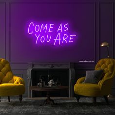 two yellow chairs in front of a purple wall with the words it's a wonderful life