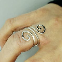 Adjustable Thumb Rings. Silver Bypass Ring For Women. Minimalist Index Finger Ring. Midi Rings. Spiral Wrap Around Rings. Gifts For Wife/Girlfriend.  This stunning spiral shaped ring will become your favorite everyday ring.  Pairs beautifully with any outfit, day or night!  Made in sterling silver wire. Each ring is entirely made by hand.   Lightly hammered to add strength by work hardening the wire. This also adds lovely texture and ensures strong durability.  Designed to be adjustable for your Bypass Rings, Index Finger Ring, Double Rings, Open Heart Ring, Gold Pinky Ring, Thumb Rings Silver, Index Finger Rings, Fine Silver Jewelry, Bypass Ring