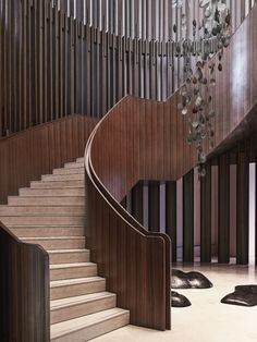 a spiral staircase with wood panels and metal railings