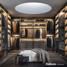 a walk in closet with lots of drawers and clothes hanging on the walls, along with a bed