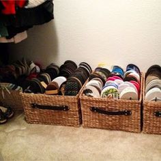 two baskets filled with shoes sitting on the floor