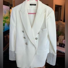 Flo Atelier White Embellished Blazer. M Beautiful, Crisp, Clean, Blazer. Great Lioness Buttons, And Absolutely Gorgeous Embellished Sleeves, (Cuffs) Tags Off, But Never Worn. Truly Unique , Really Sensational!!! Elegant White Embellished Blazer, White Embellished Long-sleeved Blazer, White Embellished Blazer For Party, Elegant White Sequined Outerwear, White Embellished Party Blazer, Embellished White Blazer, Long Sleeve Blazer With Rhinestones For Work, Elegant Long Sleeve Outerwear With Rhinestones, Embellished Sleeves