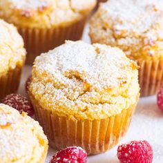 muffins with powdered sugar and raspberries on the side, ready to be eaten