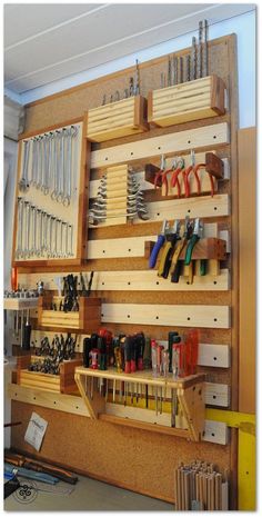 a workbench with lots of tools hanging on the wall