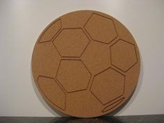 a brown plate sitting on top of a table next to a black and white wall