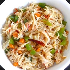 a white bowl filled with rice and vegetables