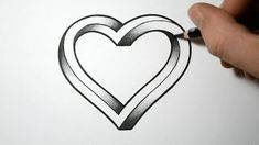 someone is drawing a heart on paper with a pen and inking it in the shape of a heart